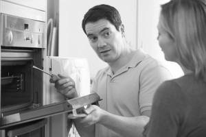Engineer Giving Woman Advice On Kitchen Repair